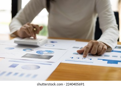 Accountant working on consolidated financial report of corporate operations, consultant auditing finance data (balance sheet, income statement) on laptop with business charts, fintech. - Shutterstock ID 2240405691