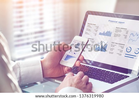 Accountant working on consolidated financial report of corporate operations, consultant auditing finance data (balance sheet, income statement) on screen with business charts, fintech, manager