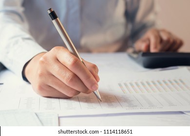 accountant working on desk to using calculator with penaccountant working on desk to using calculator with pen - Shutterstock ID 1114118651