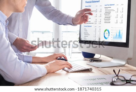 Accountants working on financial statement on computer screen in office. Team of consulant auditing finance and business operations reports with income data. Corporate management and governance