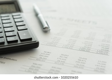 Accounting business concept. Calculator with accounting report and financial statement on desk. - Shutterstock ID 1020255610