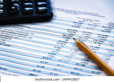 Accounting Business Concept. Calculator With Accounting Report And Financial Statement On Desk.