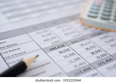 Accounting business concept. Calculator with accounting report and financial statement on desk.