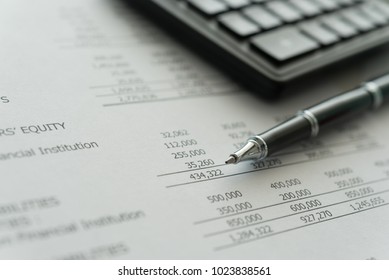 accounting business concept.  pen, calculator, financial statement on accountant's desk.