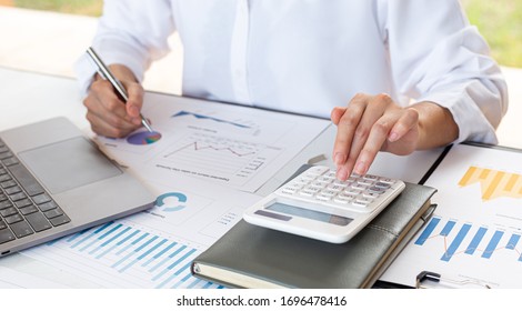 Accounting businessmen are calculating income-expenditure and analyzing real estate investment data, Financial and tax systems concept. - Shutterstock ID 1696478416