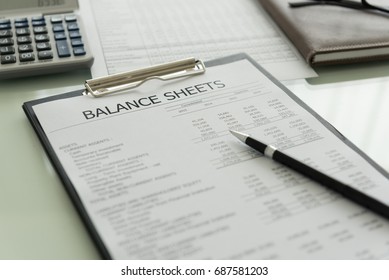 accounting concept. balance sheet and business earning report on desk. - Shutterstock ID 687581203