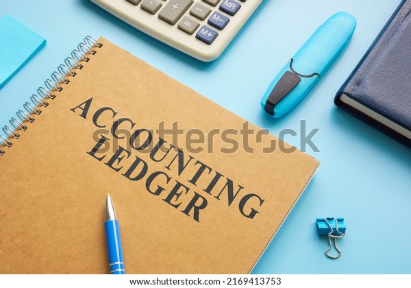 Accounting\
ledger, notepad and calculator on the\
desk.