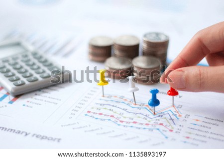 accounting,Close up of pin on graph data. business finance concept.