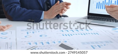 Accouters analyzing financial data using charts, graphs, and reports during an office meeting, collaborating on strategy. Business people concept