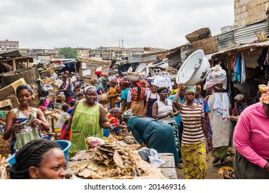 ACCRA, GHANA - MARCH 4, 2012: Unidentified Ghanaian people at the market in Ghana. People of Ghana suffer of poverty due to the unstable economic situation