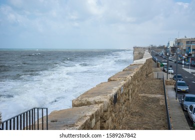 Accra, Israel2 / 18/2018, The Acre Cityscape With The St John Church, Israel. Rampart To Protect Against Waves.Street With Parked Cars