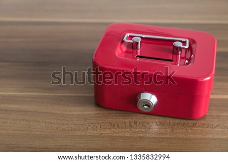 accumulate for poor people or investment .coins,hand and red moneybox on the white background for charity foundation concept.child throwing money into piggy bank.