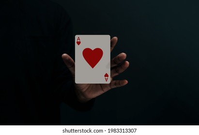 Ace Heart Playing Card. Player or Magician Levitating Poker Card on Hand. Metaphor of Love, Happiness and begin a Good Relationship.Front View. Closeup and Dark Tone