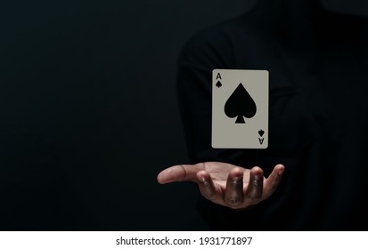 Ace Spade Playing Card. Levitating Poker Card On Hand. Front View. Closeup And Dark Tone