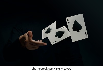 Ace Spade Playing Card. Player or Magician Throwing and Levitating Poker Card by Hand. Front View. Closeup and Dark Tone