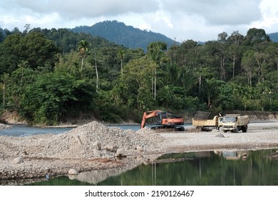 Aceh Barat Daya, Indonesia - August 7, 2022 This Is A Natural Sight Showing An Oren Colored Excavator Car And A Sand Transport Car From Afar Located In Blangpidie Abdya 