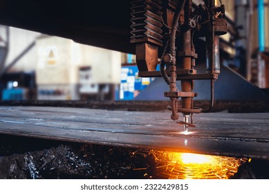 Acetylene torch semi auto machine cutting metalwork fabrication with bright sparks in factory. - Powered by Shutterstock