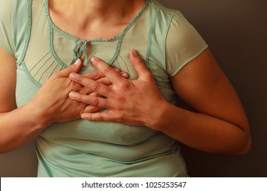 Aches And Pains Concept. Sick Woman Having Bad Ache And Pain Heart Attack Health Problem. Female Placing Hands On Her Chest. 