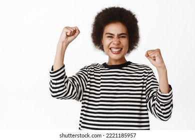 Achievement. Ethusiastic Black Girl Winning Prize, Celebrating Victory, Success, Making Fist Pump And Smiling Satisfied, Standing Over White Background