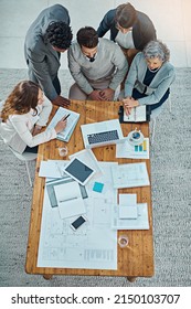 Achieving Results Is A Team Effort. High Angle Shot Of A Group Of Businesspeople Having A Meeting In An Office.