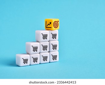 Achieving the sales goals and business growth. Setting the sales target objectives. Shopping cart, target and ascending graph symbols on cubes.