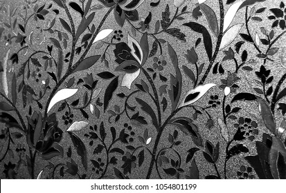 Achromatic Or Black & White Photo Of Floral Patterned Privacy Window Cling With The Sun Shining Through It