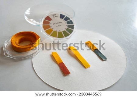 Acid - base detection through litmus paper. The color of the paper identifies an acid or basic solution