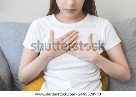 Acid reflux disease, suffer asian young woman have symptom gastroesophageal, esophageal, stomach ache and heartburn pain hand on chest from digestion problem after eat food, Healthcare medical concept