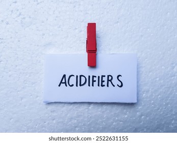 Acidifiers writting on table background.