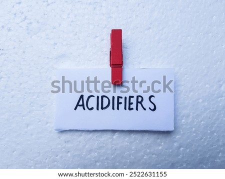 Acidifiers writting on table background.