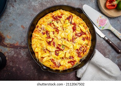 Ackee Frittata sometimes known as Ackee Quiche, baked into a cast iron skillet topped with bacon and cheese
