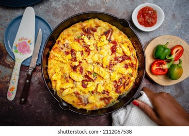 Ackee Frittata sometimes known as Ackee Quiche, baked into a cast iron skillet topped with bacon and cheese

