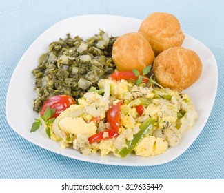 Ackee & Saltfish - Traditional Jamaican dish made of salt cod and ackee fruit. Served with callaloo and johnny cakes.