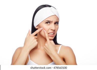 Acne treatment. Acne woman. Acne skin. Shocked Woman Looking At Pimple On Forehead. Young Woman Squeezing her Pimple, Removing Pimple from her Face. Woman Skin Care Concept