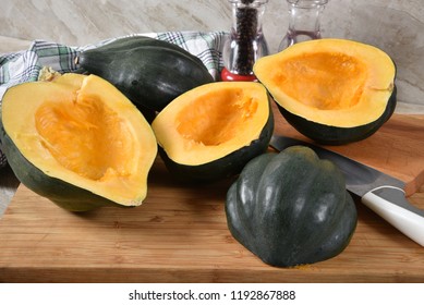 Acorn Squash Cut In Half With The Seeds Removed On A Cutting Board