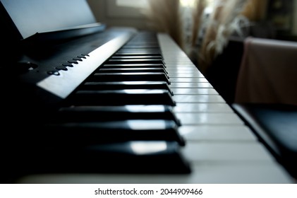 acoustic or digital piano keyboard, black and white piano keys, music equipment. 