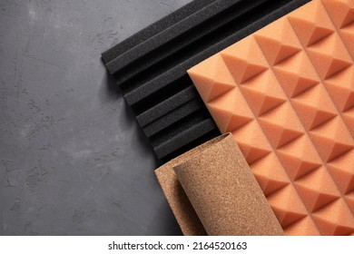 Acoustic foam and cork board at concrete wall background texture. Sound isolation material for record studio or house renovation - Shutterstock ID 2164520163
