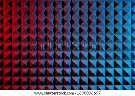 Acoustic foam panel background with red and blue lighting. Music background