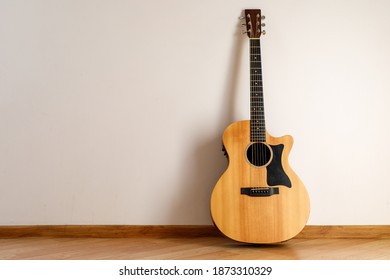 Acoustic Guitar Against The Wall