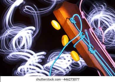 Acoustic guitar with electroluminescent wire for strings and light trails - Powered by Shutterstock