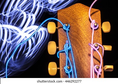 Acoustic guitar with electroluminescent wire for strings and light trails - Powered by Shutterstock