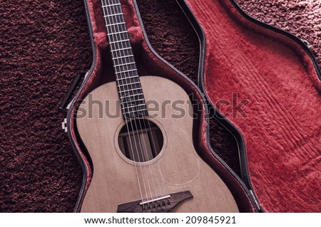 Acoustic guitar in its flightcase