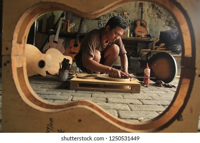 An Acoustic Guitar Maker Is Busy Working On His Order. Surabaya Indonesia 2017