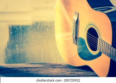 Acoustic Guitar Next The Window With Drop Water