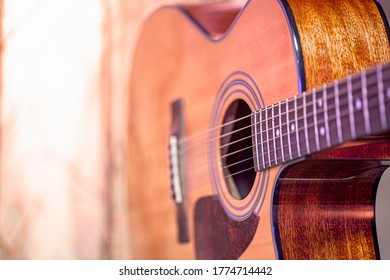Acoustic guitar on a beautiful colored background. The concept of stringed instruments. Close up.