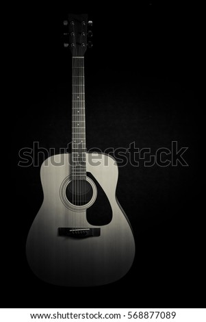 Acoustic guitar on black background with copy space,black and white