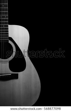 Acoustic guitar on black background with copy space,black and white