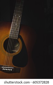 Acoustic Guitar On A Dark Background