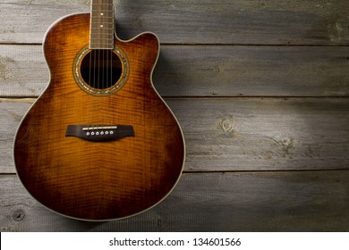 Acoustic Guitar On Wood Background