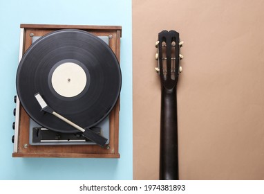 Acoustic guitar and retro vinyl record player on blue brown background. Musical concept. Top view. Flat lay - Powered by Shutterstock